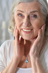 Portrait of beautiful senior woman posing at home