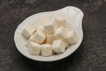 Refined white sugar cubs in the bowl