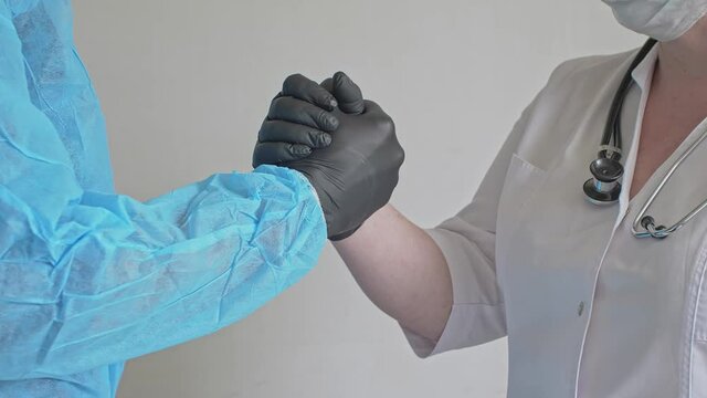 The concept of cooperation of medical specialists doctors friendly shake hands Coordinated work of doctors Collaboration of specialists