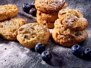 Bakers gonna bake. Serving food on slate. Oatmeal cookies biscuit with blueberry on dark tiles countrylike. Chocolate chip cookies shop on window display. Lunch in inexpensive cafe.