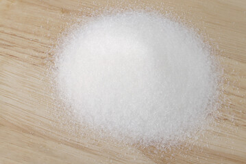 Sweet sugar on wooden background. 