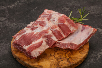 Raw pork ribs served rosemary
