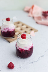 Mix berry smoothie with raspberry, blackberry and yogurt in glass jars at light background