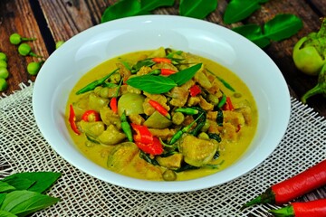 Thai authentic spicy green curry with beef and round eggplants.