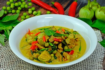 Thai authentic spicy green curry with beef and round eggplants.