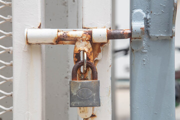 The door is closed with an old metal lock.