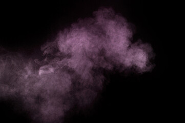 Purple powder explosion on black background. Colored powder cloud. Colorful dust explode. Paint Holi.