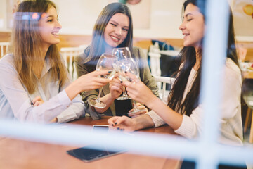 Three female friends enjoying meeting in cozy cafe