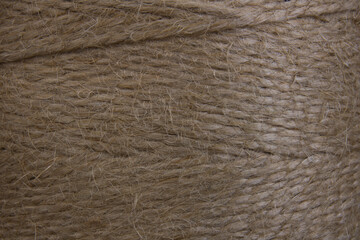 Skein of coarse brown twine, closeup. Background texture. Environmental materials, recycling, packaging.