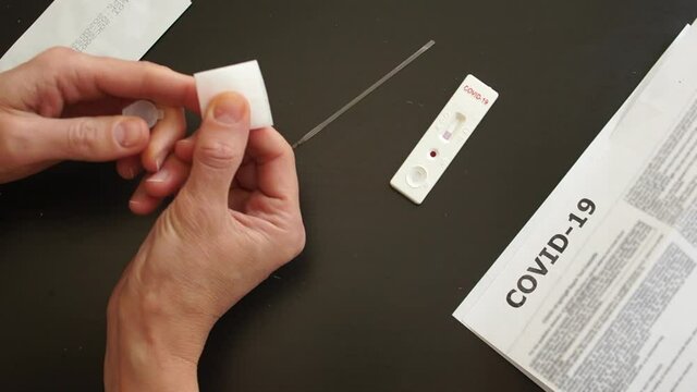 Rapid test covid 19. Test cassette and a kit of reagents for self-sampling of blood for analysis on coronovirus covid-19. The reaction in the cartridge after mixing the reagents. Part 2
