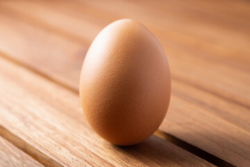 fresh clean chicken egg on a wooden  brown table as a background. concept of organic food, good health and high protein for cooking breakfast