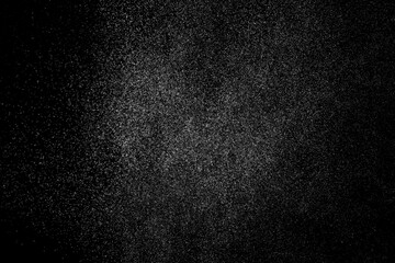 Abstract splashes of water on black background. Freeze motion of white particles. Rain, snow overlay texture.