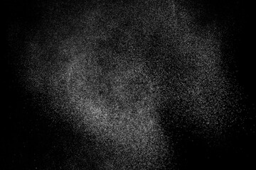 Obraz premium Abstract splashes of water on black background. Freeze motion of white particles. Rain, snow overlay texture.