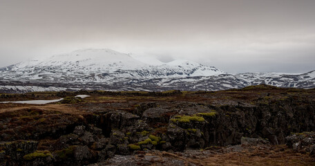 Geology rock formations and snowcapped mountain in Iceland.