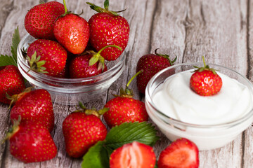 fresh strawberries with greek yogurt on  wooden background with copy space