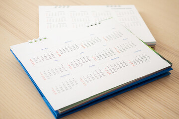 Obraz premium Calendar page close up on wood table background business planning appointment meeting concept