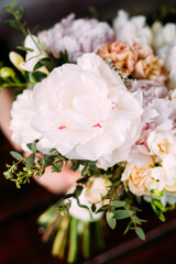Elegant spring wedding bouquet with tender white peonies, fresh flowers.
