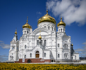 Fototapeta na wymiar Belogorsk monastery, Perm, Russia with yellow flowers
