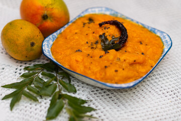 Goan Mango Curry dish with copy space. Restaurant and food magazine image of mango curry.  Goan Mango Sasav dish.