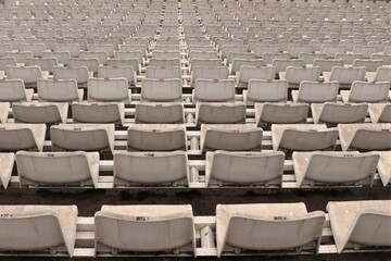 
White plastic seats in an empty stadium