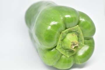 Green bell pepper on white background.