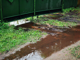 puddle in front of the metal gate