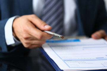 Focused photo on male hand that holding silver pen
