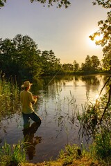 angler catching the fish during sunny day