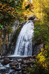 Waterfall in the autumn mountain forest. Russia, Altai Republic, Turochaksky district, Korbu waterfall