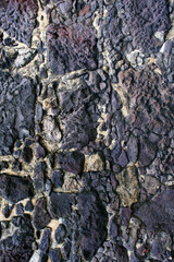 Close Up of a Wall with Black Stones