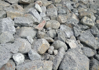 pile of stones strewn with sand