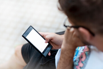 man looking at smartphone with flat copy space from above