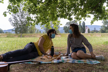 A couple having a picnic in the middle of nature. Having breakfast and enjoying the day.
