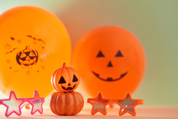 Bright halloween decoration for holiday. Glasses and air balloons on green background. Autumn festive event concept