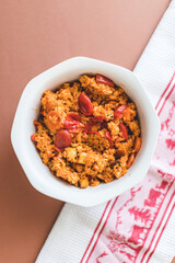 paella vegan dish from Spain with rice smoked tofu peppers tomatoes fried on a pan