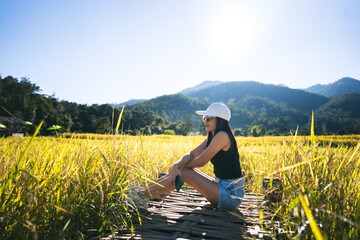 Solo traveller adult woman relax at rice field.