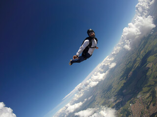 Skydiver jumping free with the clouds.