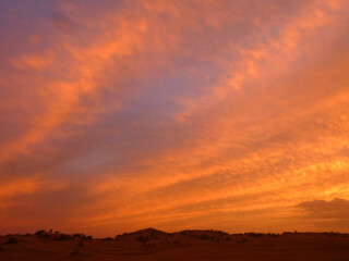 Sunset over Sahara desert with gentle colours and clouds