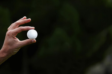 close up, golf player holding golf ball with big copy space for your text message
