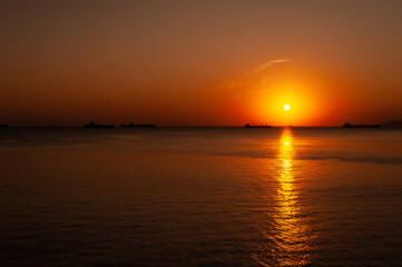 Fototapeta na wymiar A sunset over a body of water