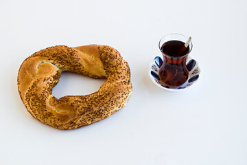 Traditional,Crunchy Turkish Bagel,Simit with Turkish Tea on the white surface with copy space