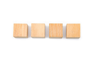 Wooden cubes on a white background. Four identical cubes lie, stand in a row together and separately, directly and at an angle. Place for text