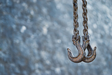 Big metal hooks on chain.