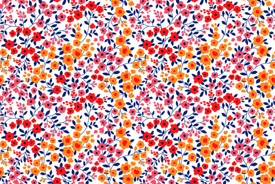 Floral pattern. Pretty flowers on white background. Printing with small orange, red and pink flowers. Ditsy print. Seamless vector texture. Spring bouquet.