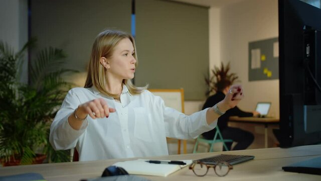 Confident Caucasian blonde young woman looking at monitor professional goals achieve, modern workplace office pleasant female in white shirt holding pen work job project brainstorm business concept