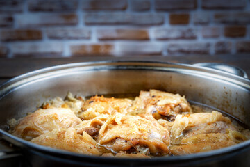 Chicken thighs fried in a pan, close-up, shallow depth of field, selective focus. Homemade food concept.