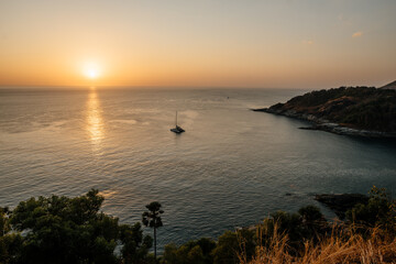 Fototapeta premium Thailand, 2020: drone shot from above, panoramic ocean view on sunset with trees and cliffs