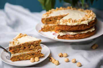 Piece of carrot cake with carrot cake on the background