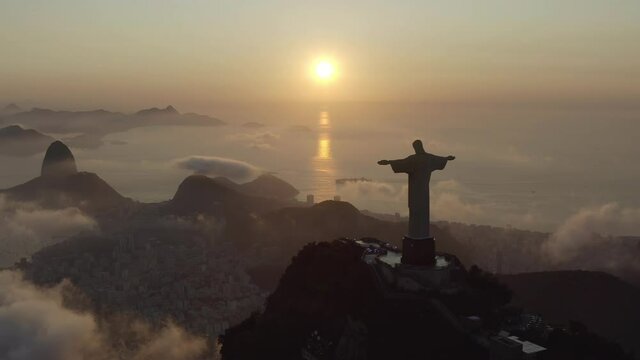 Drone, aerial footage of a silhouette of Christ the Redeemer over morning clouds in the summer Rio de Janeiro Brazil