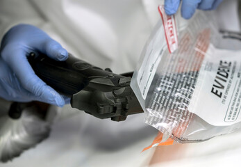 Fototapeta na wymiar Scientific police officer examining traces of a gun in ballistic laboratory